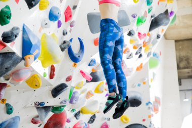 woman climbing the wall at gym
