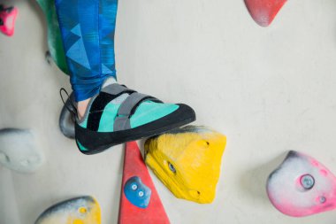 woman climbing the wall at gym