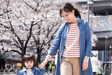 Annesiyle yürüyen sevimli Japon çocuğunun portresi.