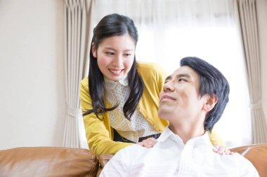 Genç adam evde karısından masaj alıyor. 