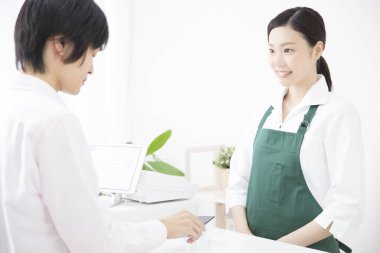 Akıllı telefonlu bir adam dükkanda online ödeme yapıyor. 