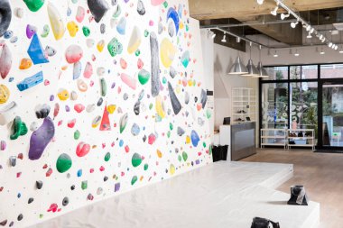 İçerideki tırmanma salonunda renkli duvar tutucuları var.