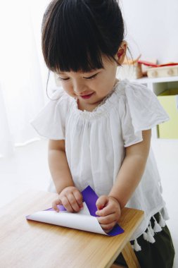Oturma odasında oynayan küçük tatlı bir Japon kız.