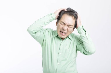 Başı ağrıyan yaşlı Asyalı adam beyazda izole edilmiş. 