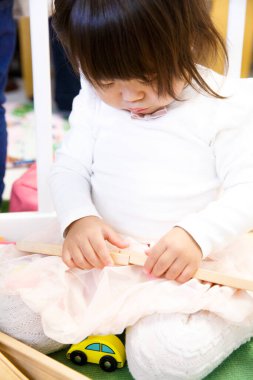 Anaokulunda oyuncak oynayan tatlı Asyalı kız.
