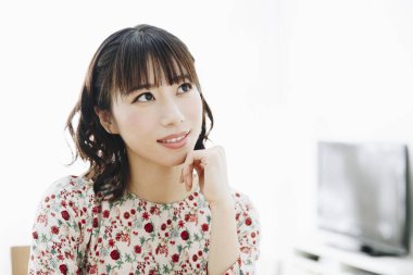 Odada oturan Asyalı kadın. 