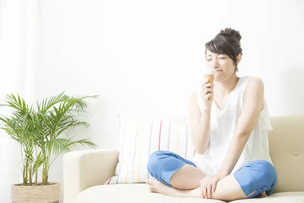 woman eating an ice cream  at home