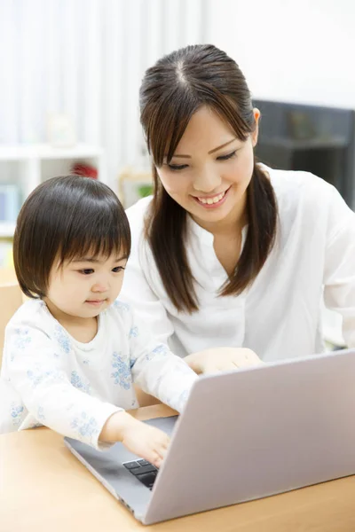 Young Mother Little Daughter Using Laptop Home Stock Picture