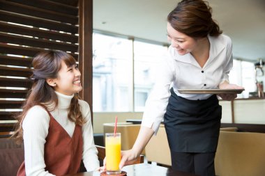 Garson kafede müşteriye sipariş veriyor. 