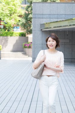 Şehirde yürüyen Asyalı kadın.