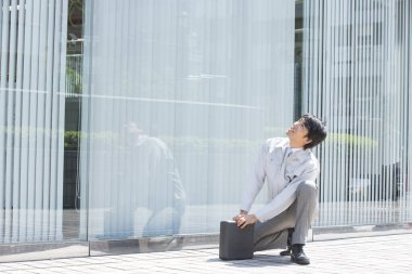 Sokakta alet çantası olan yakışıklı Asyalı bir işçi. 