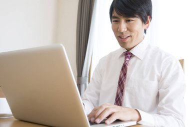 Dizüstü bilgisayar kullanan genç Asya iş adamı