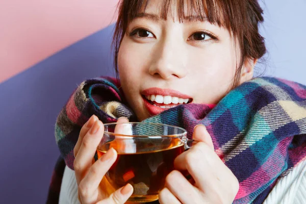 Genç Asyalı kız çay içiyor, stüdyo fotoğrafı. 