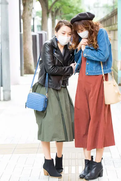 young women with face  masks on street
