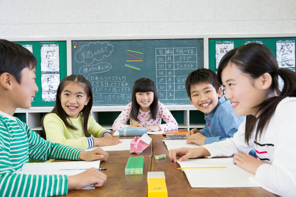 Asian school children studying at classroom