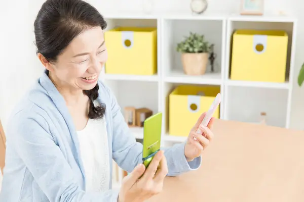 Close Senior Asian Woman Comparing Two Phones — Stock Photo, Image