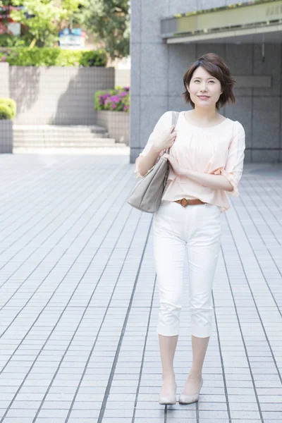 stock image asian young woman walking in city