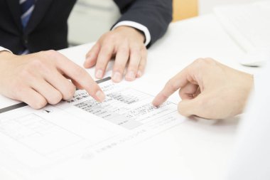 Ofiste mali belgelerle çalışan iş adamlarının elleri