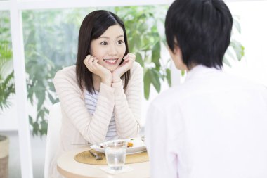happy asian woman having a meal with man 
