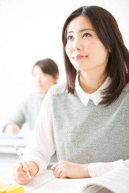 Sınıftaki Asyalı kadın öğrenci.