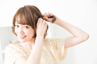 Gülümseyen Asyalı kadın örgü örüyor, kapat.