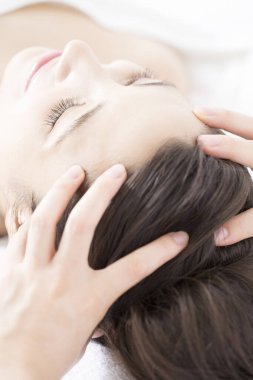 Genç bir kadın spada masaj yaptırıyor.