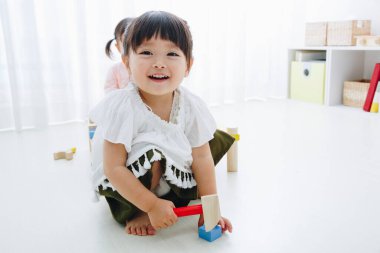 Ev içi oyuncaklarla oynayan sevimli Japon kızlarının yakın çekimleri. 