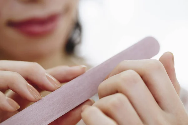 woman with nail file