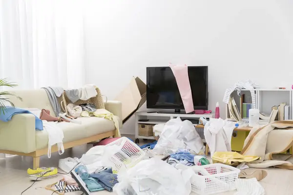 Messy apartment interior with clothes. Clutter concept