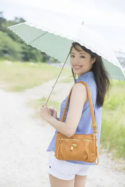 beautiful smiling Japanese woman with umbrella