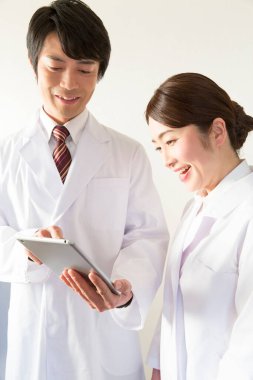 Tablet bilgisayar kullanan Asyalı doktorlar 