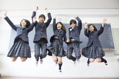 Sınıfa atlayan genç Japon öğrencilerin portresi.