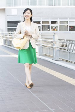 Şehirde yürüyen Asyalı kadın.