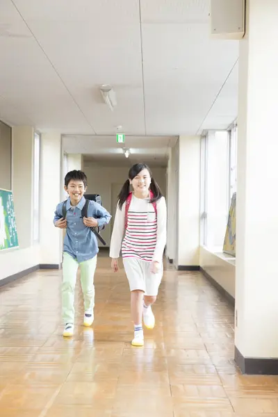 Okul Koridorunda Koşan Iki Mutlu Okul Çocuğunun Portresi — Stok fotoğraf