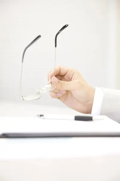 Dłonie Biznesmena Trzymające Okulary Przy Biurku — Zdjęcie stockowe