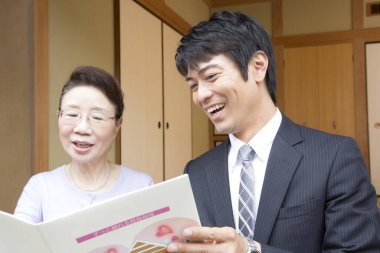 Gülümseyen adam ve kadın dergi okuyor.