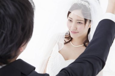 Beyaz arka planda Asyalı bir çiftin düğün resmi 