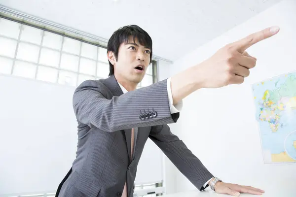 stock image Japanese businessman gesturing in office 