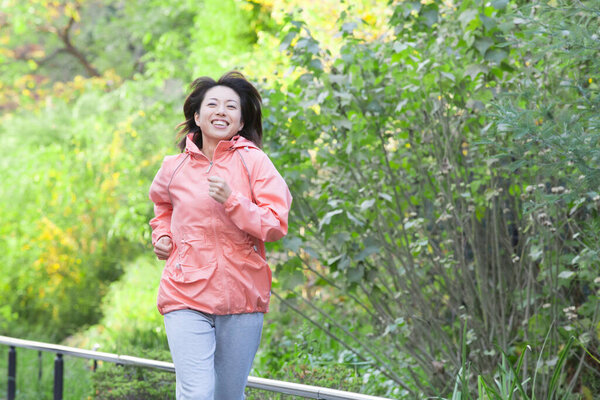 mature woman running  in the park