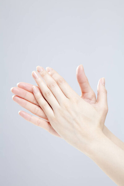 Closeup of female hand gesturing on white background 