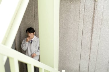 Sigara içen Asyalı adam.