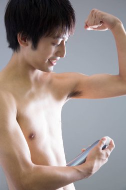 Genç Asyalı sprey kullanıyor. 