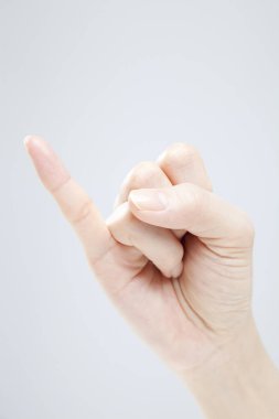 Beyaz arka planda el hareketi yapan kadınların yakın çekimi. 