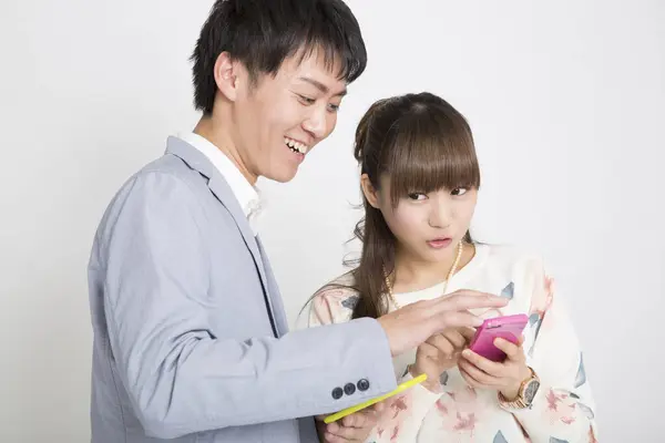 Asian Young Couple Mobile Phones Studio Shot — Stock Photo, Image