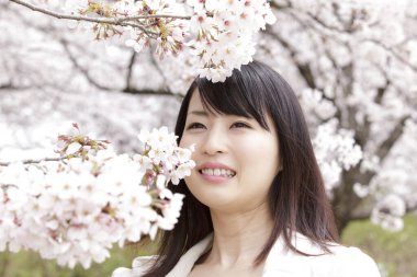 Kiraz çiçekli güzel Asyalı kadın.