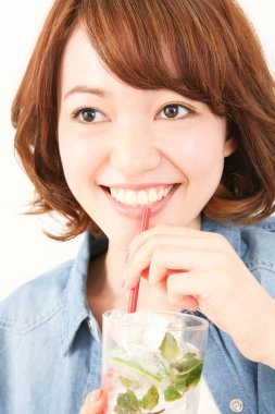 Güzel Japon kadın naneli ferahlatıcı soğuk içecek içiyor.