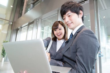 İş adamları dizüstü bilgisayar kullanıyor ve tartışıyorlar