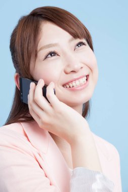 Telefondaki kadın gülümsüyor, stüdyo fotoğrafı.