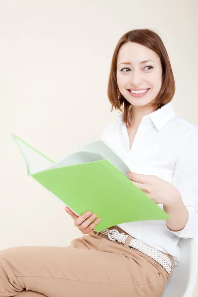 young asian woman with folder  in hand