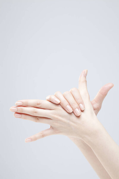 Closeup of female hand gesturing on white background 